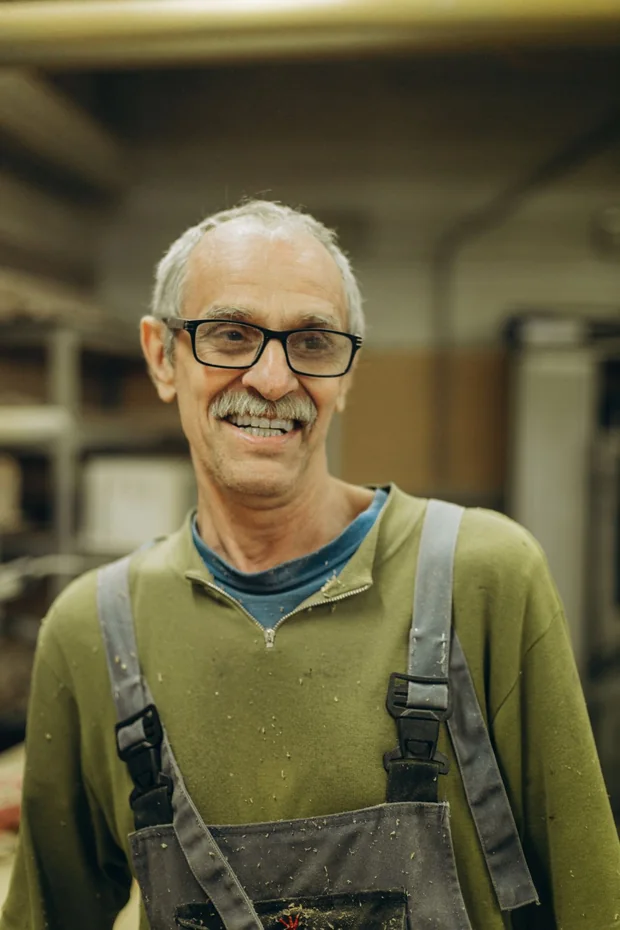 Ray Halsted in work overalls, smiling in the Elston Avenue shop